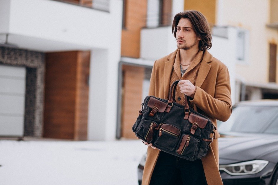 A Man Wearing a Jacket and Carrying a Bag